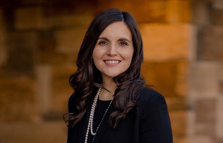 A smiling woman in business attire